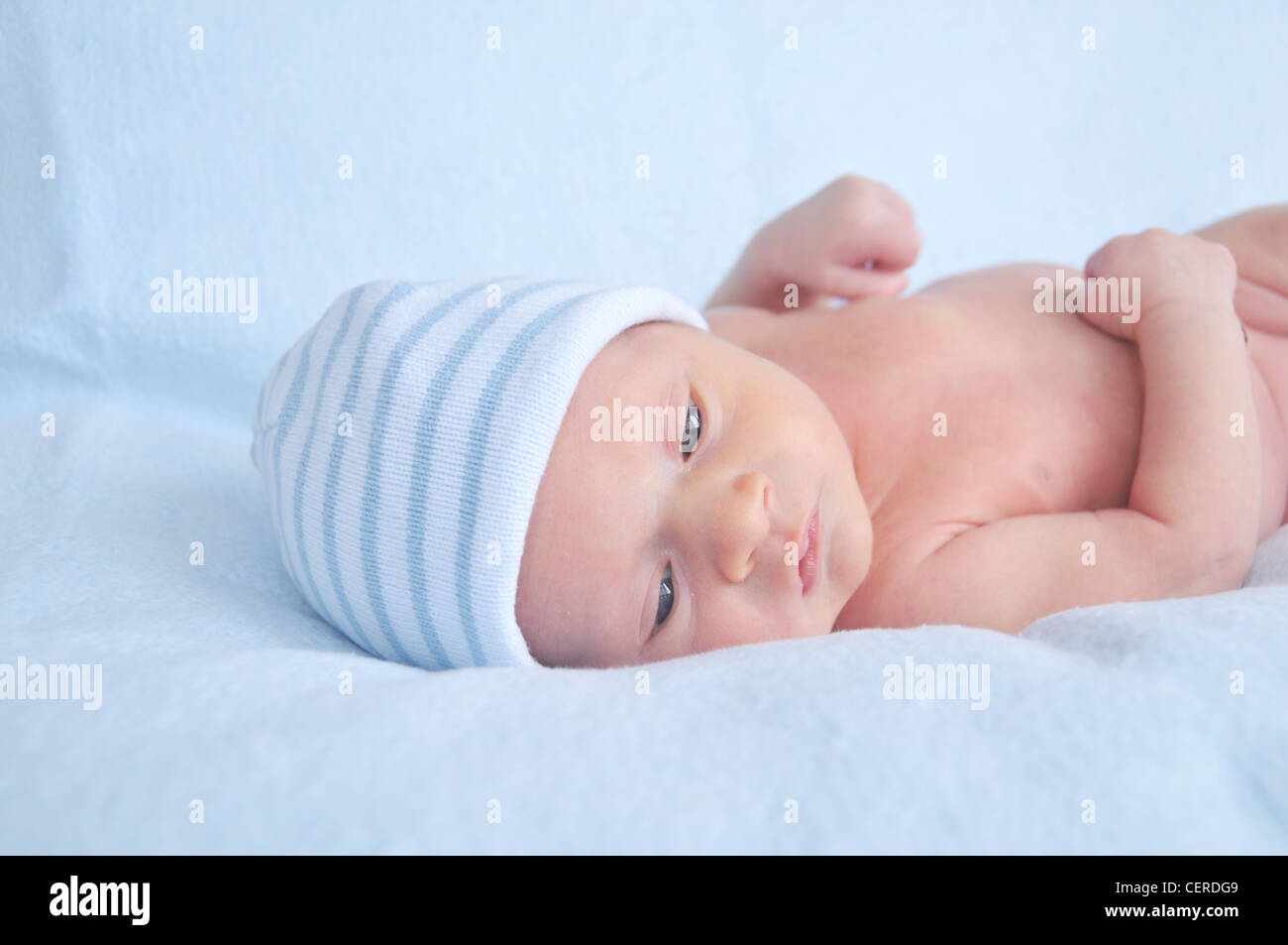 Newborn baby boy in a blue hat Stock Photo - Alamy