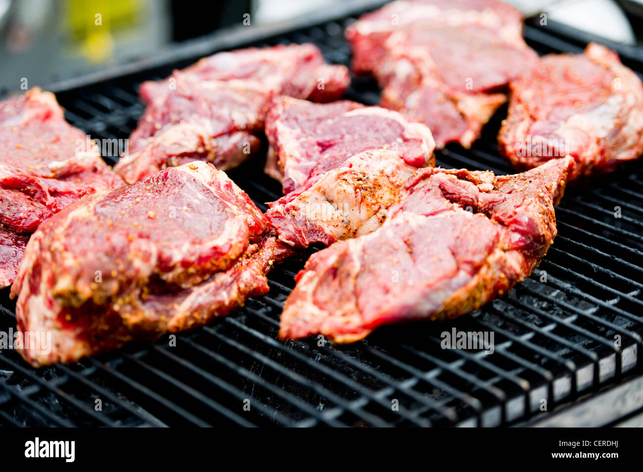 Seasoned beef cooking on the grill Stock Photo
