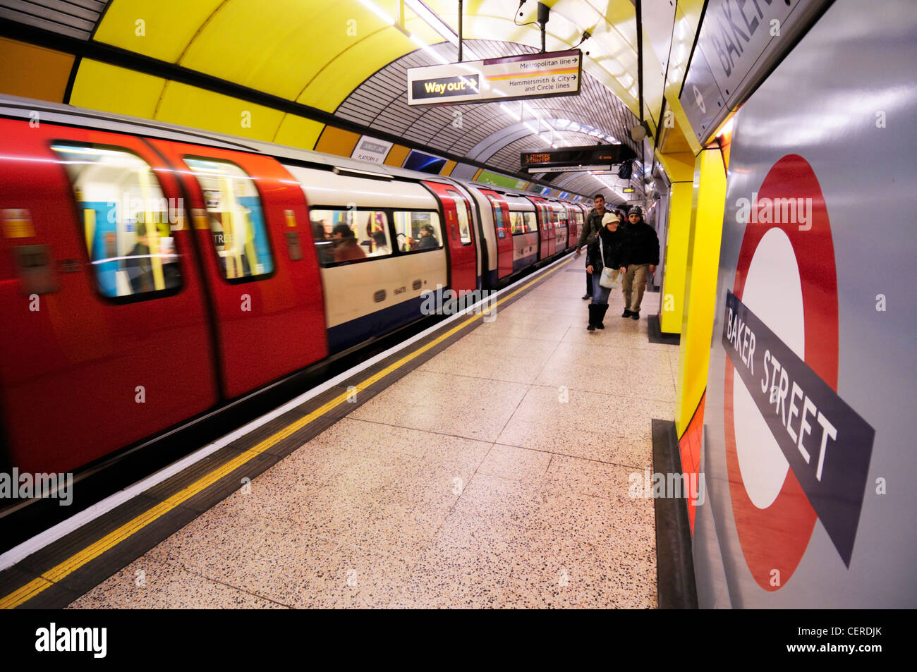 Passengers walking towards the exit along a Jubilee line platform at Baker Street Underground Station. Stock Photo