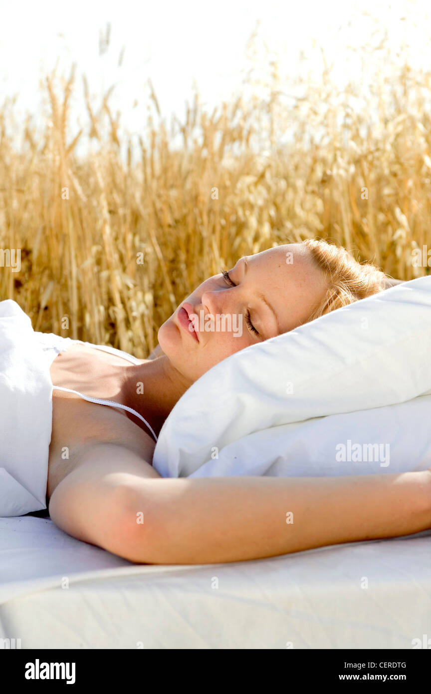 Lower Part of Female Body Wearing White Sleepwear Lying on Bed