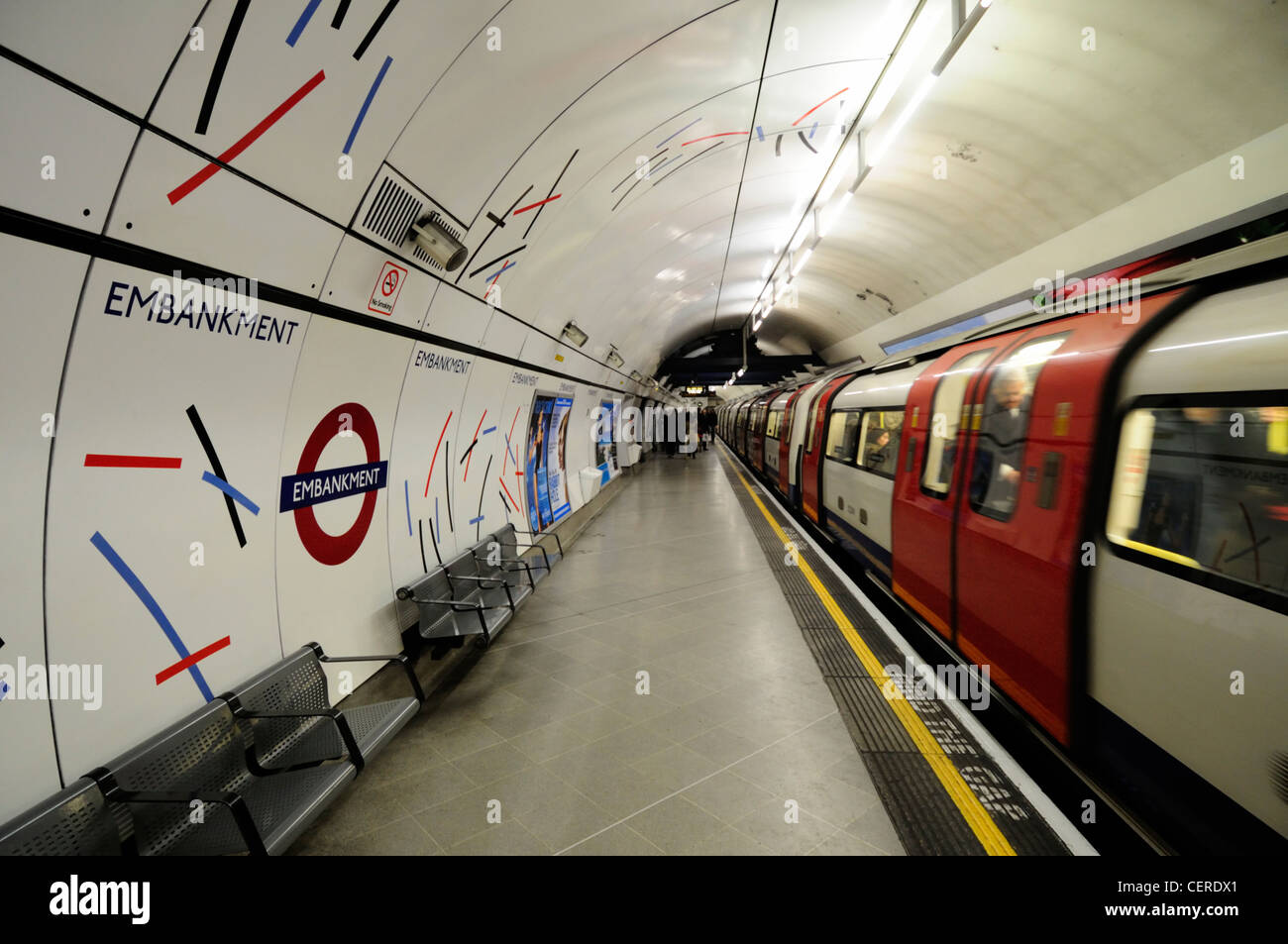 A Northern line tube train departing from Embankment Underground station. Stock Photo