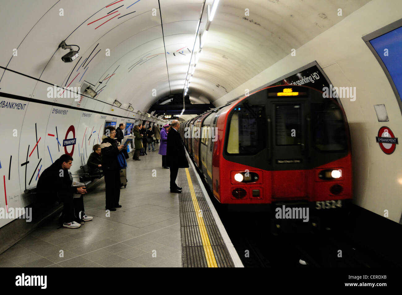 A Northern line tube train arriving at Embankment Underground station. Stock Photo