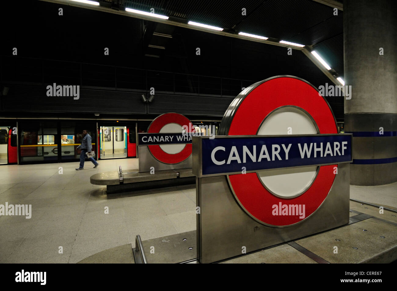 A tube train waiting at a platform in Canary Wharf Underground Station. Stock Photo