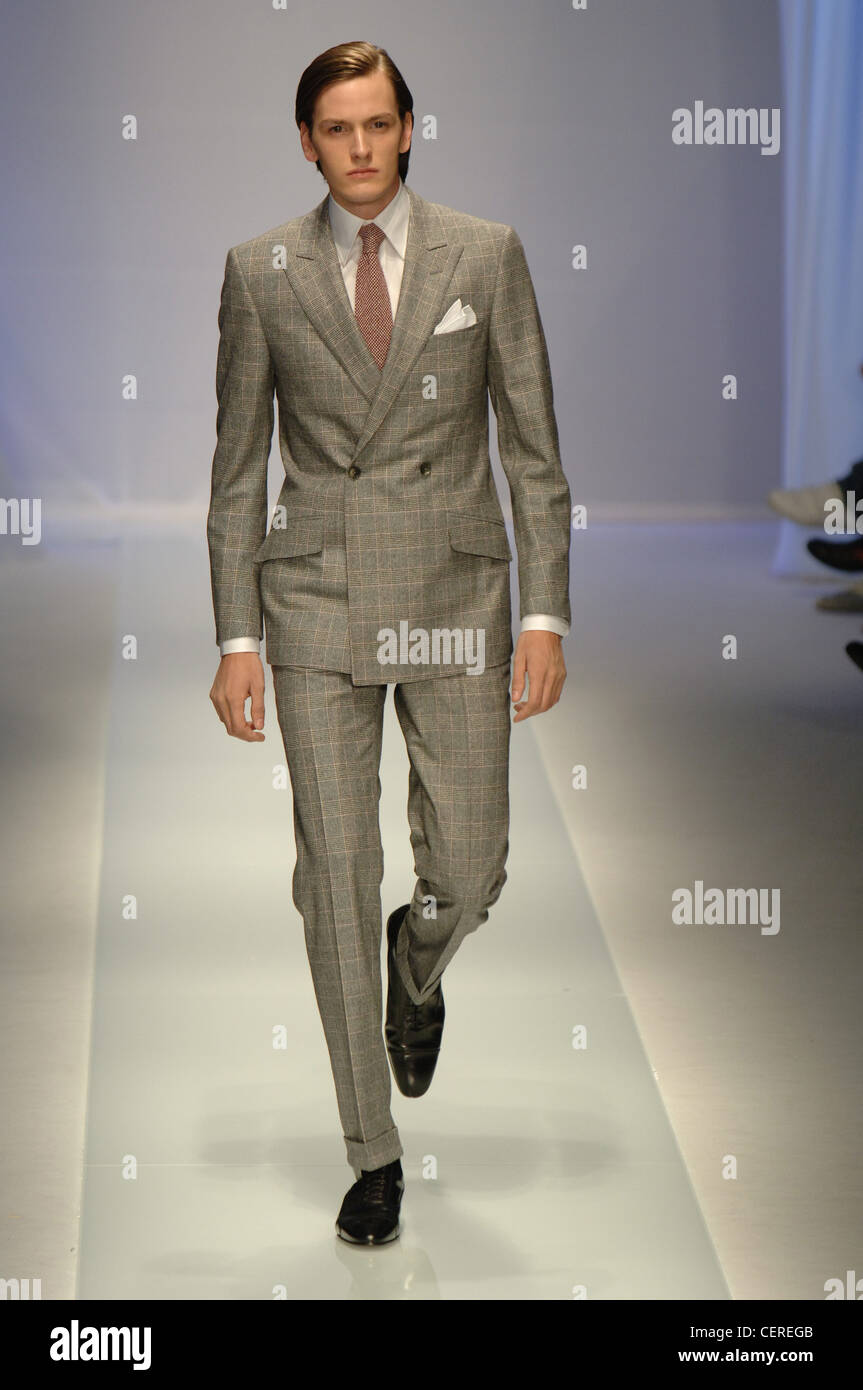 Milan Valentino Menswear Ready to Wear Slim Suit: Model hair slicked to one  side wearing grey checked suit cream shirt and Stock Photo - Alamy