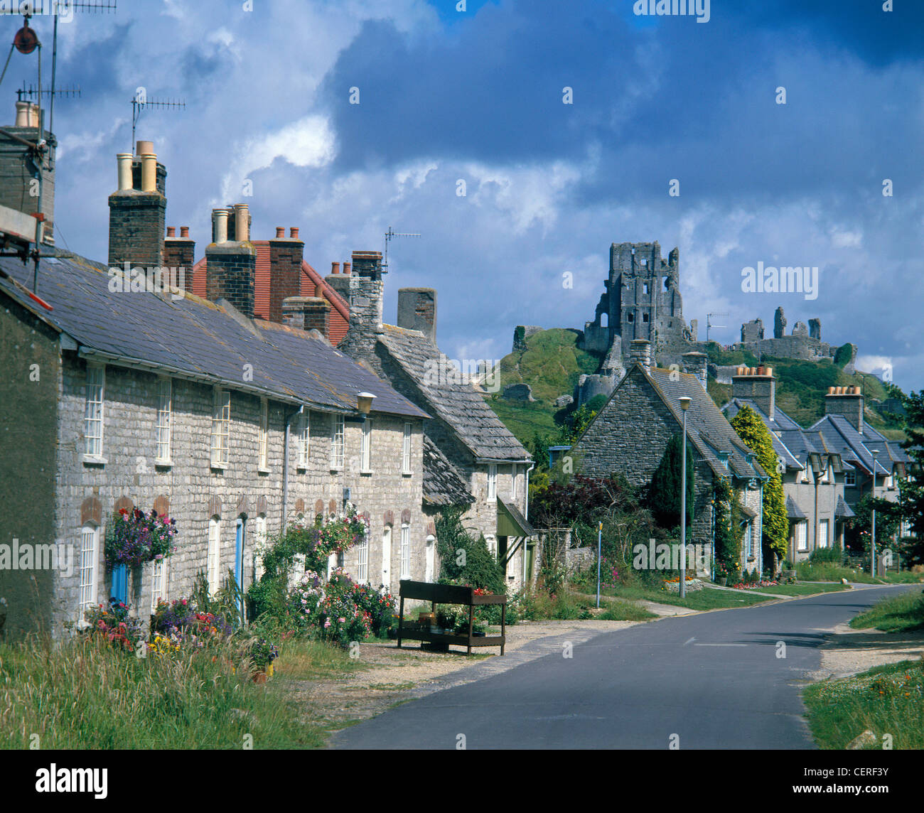 A view of the castle at Corfe with olde world cottages in West Street Stock Photo Alamy