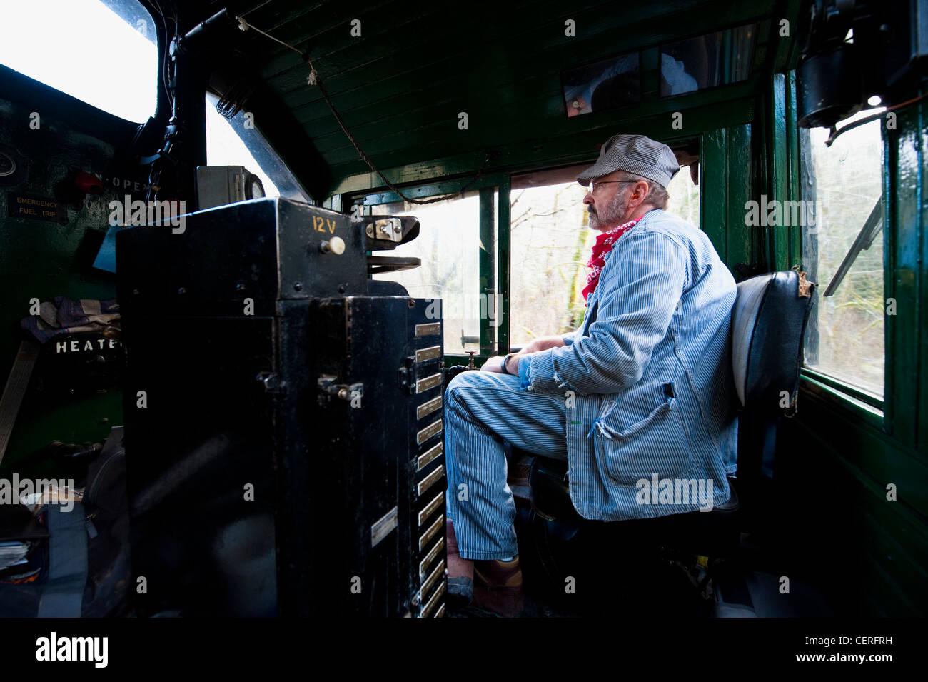 A train engineer driving an antique diesel on the Lake