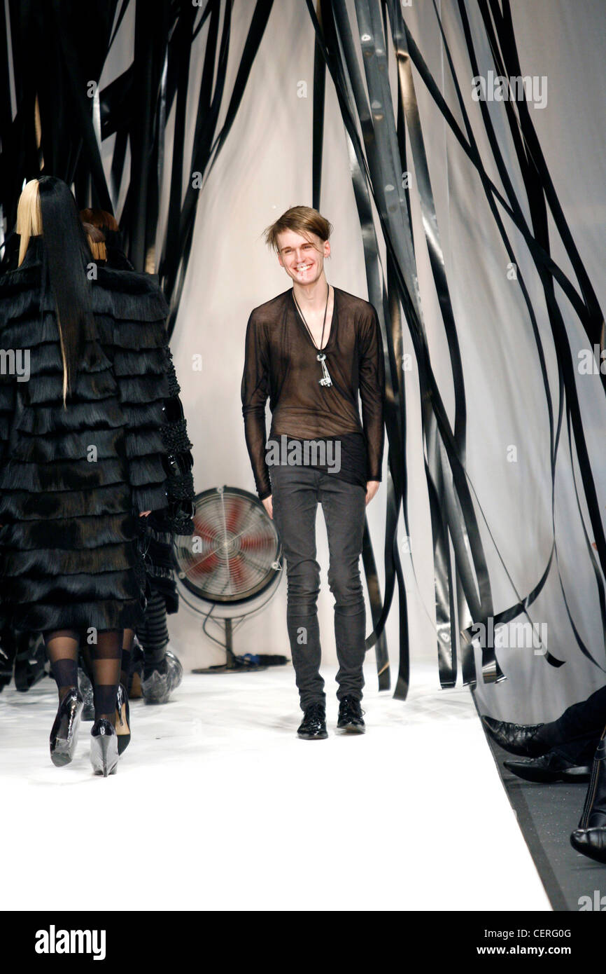 Gareth Pugh London Ready to Wear Autumn Winter Designer Gareth Pugh wearing  black seethrough top and very tight grey jeans Stock Photo - Alamy