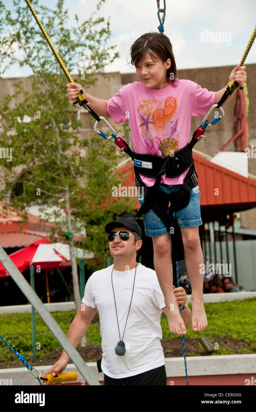 A girl on a  bungee trampoline with  elastic ropes New Orleans Stock Photo