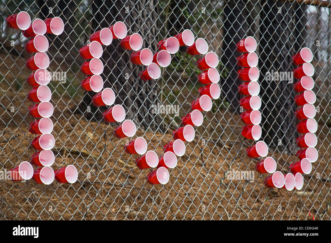 Using red and white plastic cups on a chain link fence to spell 'I Love You' at WT Woodson High School in Fairfax Virginia Stock Photo