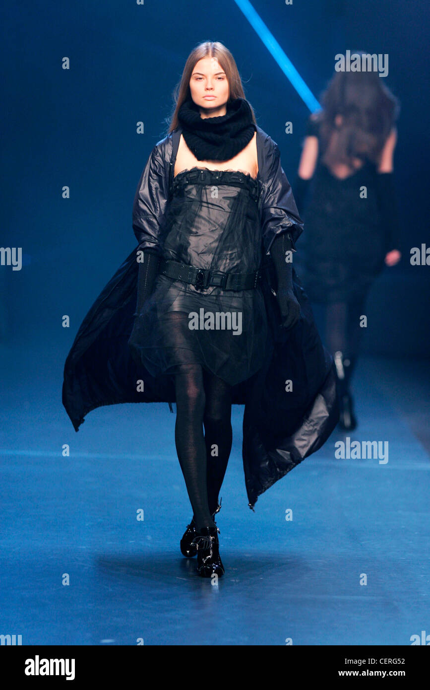 Costume National Milan Fashion Week Autumn Winter Model wearing black shiny strapless mini dress net overlay, wide belt, black Stock Photo