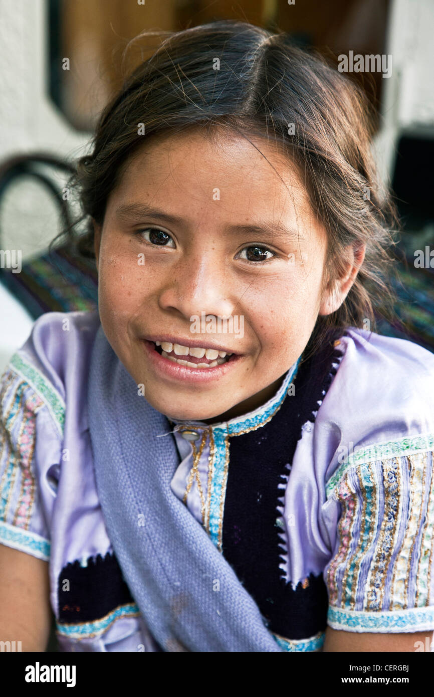 small Mexican indigenous Indian girl vendor with bright eyes sweet smile selling gum & candy to tourists in Zocalo Oaxaca Mexico Stock Photo