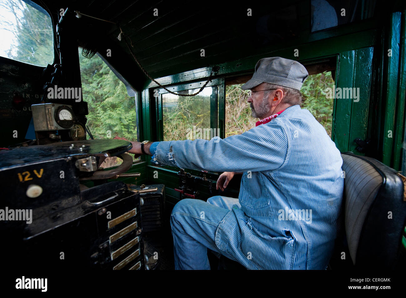 A train engineer driving an antique diesel on the Lake