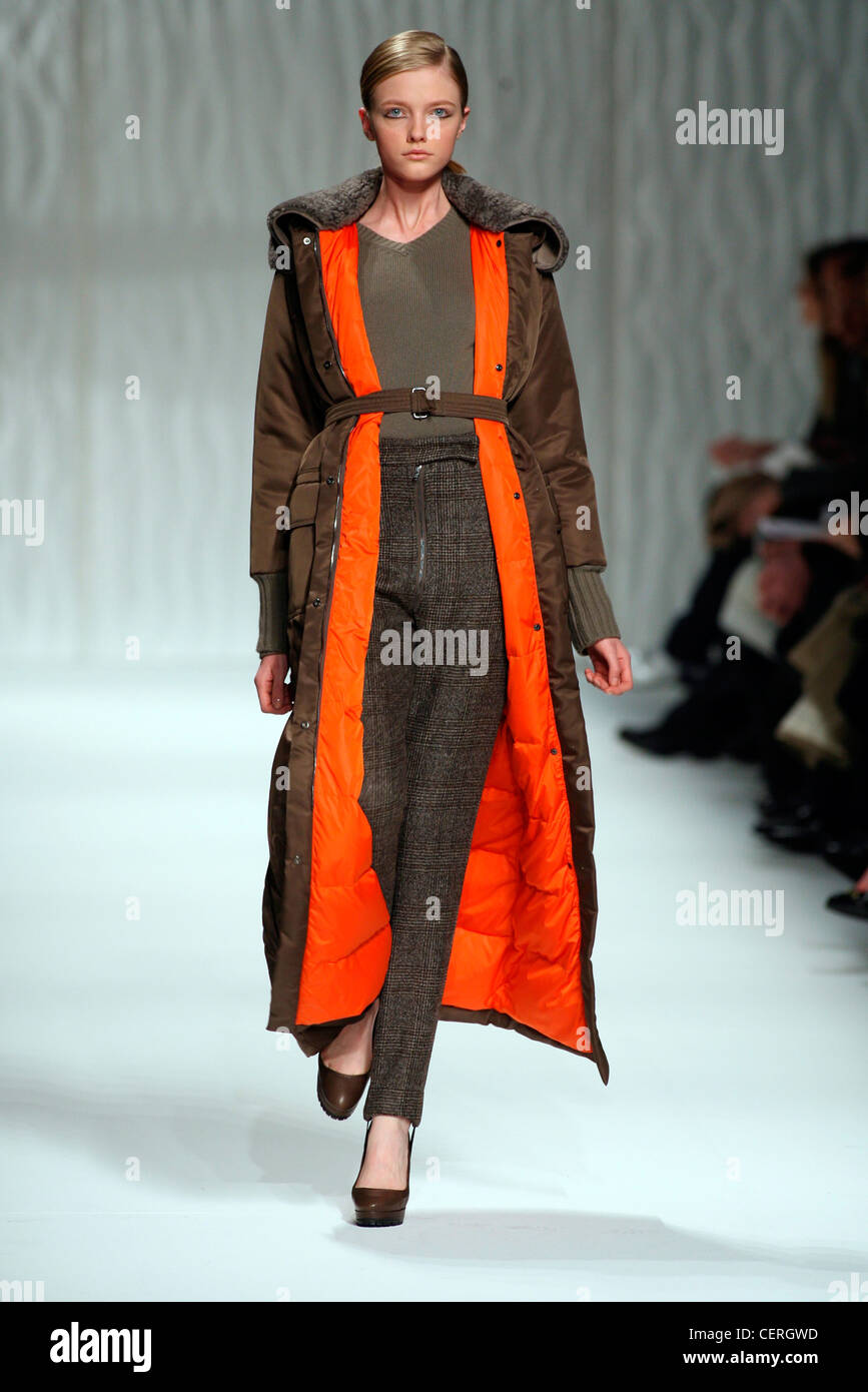 Max Mara Milan Ready to Wear Autumn Winter Long brown quilted coat orange  lining, over olive blouse, tweed checked trousers and Stock Photo - Alamy