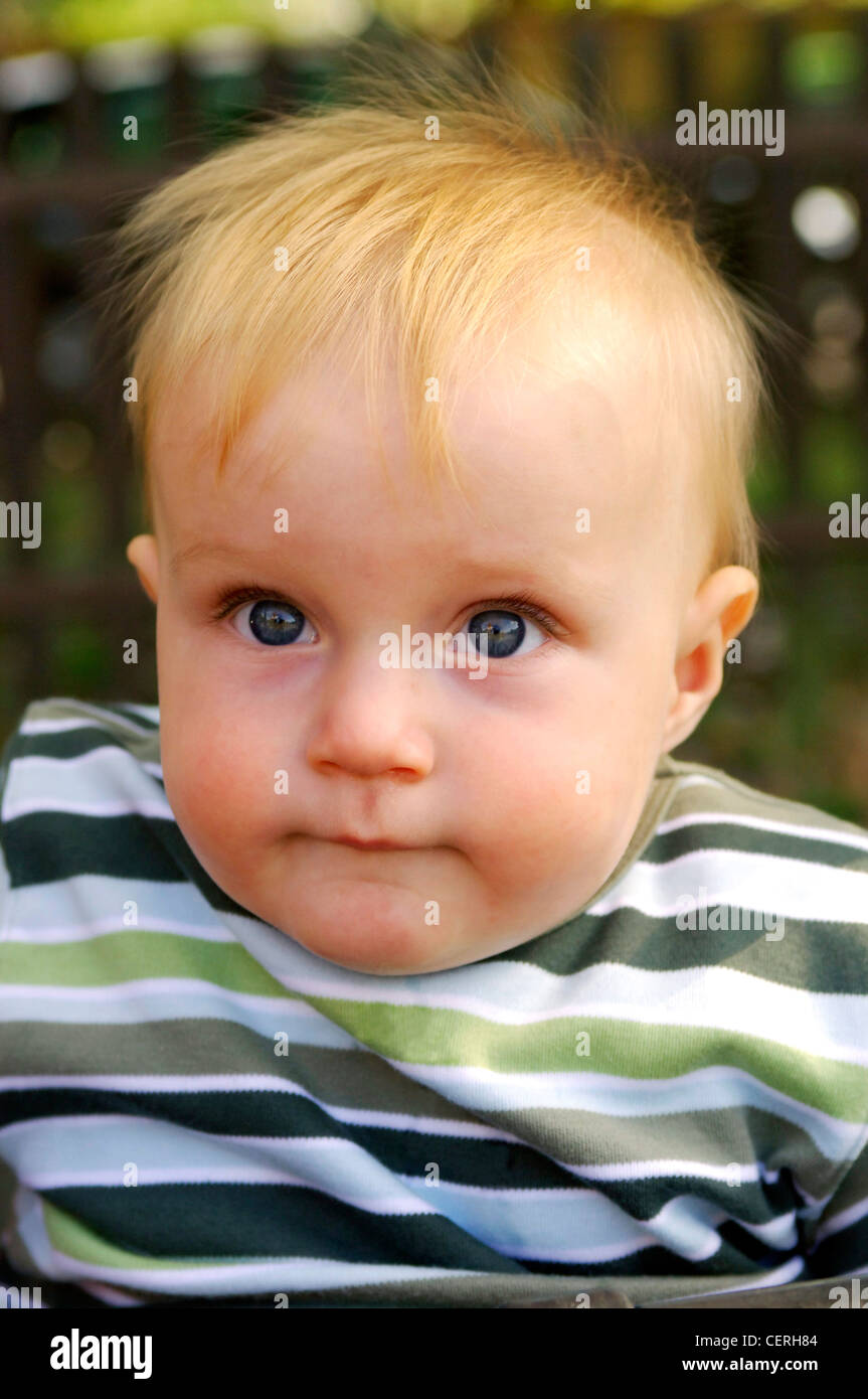 blonde hair boy mouth Male child with blonde hair wearing stripy top looking up mouth closed  Stock Photo - Alamy