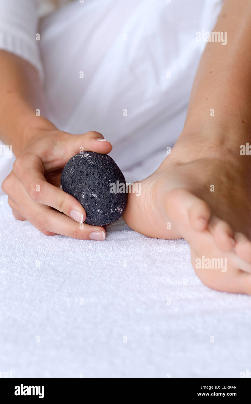 Female exfoliating feet with pumice stone Stock Photo Alamy