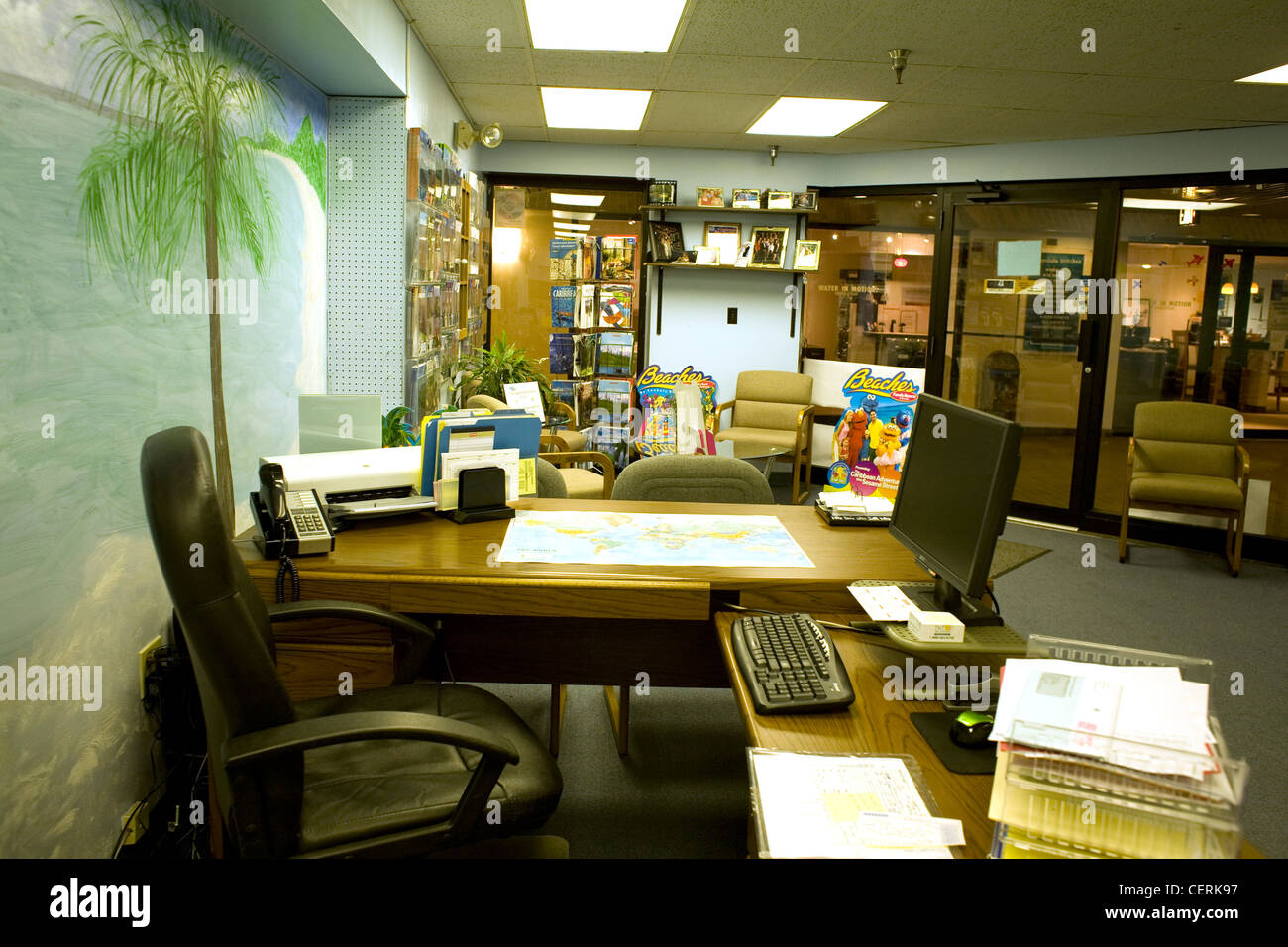 Interior of a travel agency office in Pittsfield, MA has hand-painted tropical scene on wall. Stock Photo