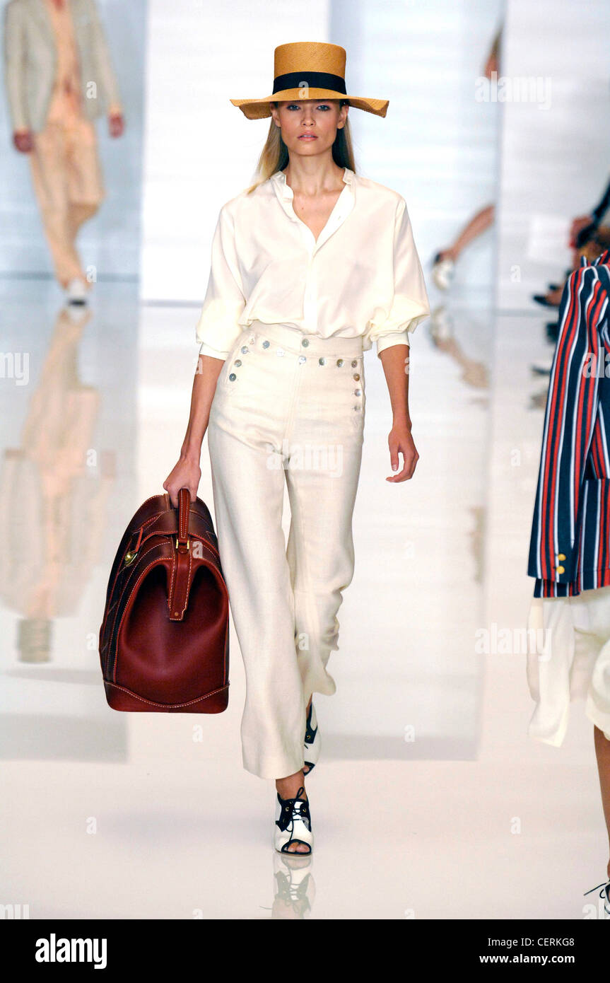 Tommy Hilfiger New York Ready to Wear Spring Summer wearing white blouse, high waisted white trousers, up shoes, look Stock Photo - Alamy