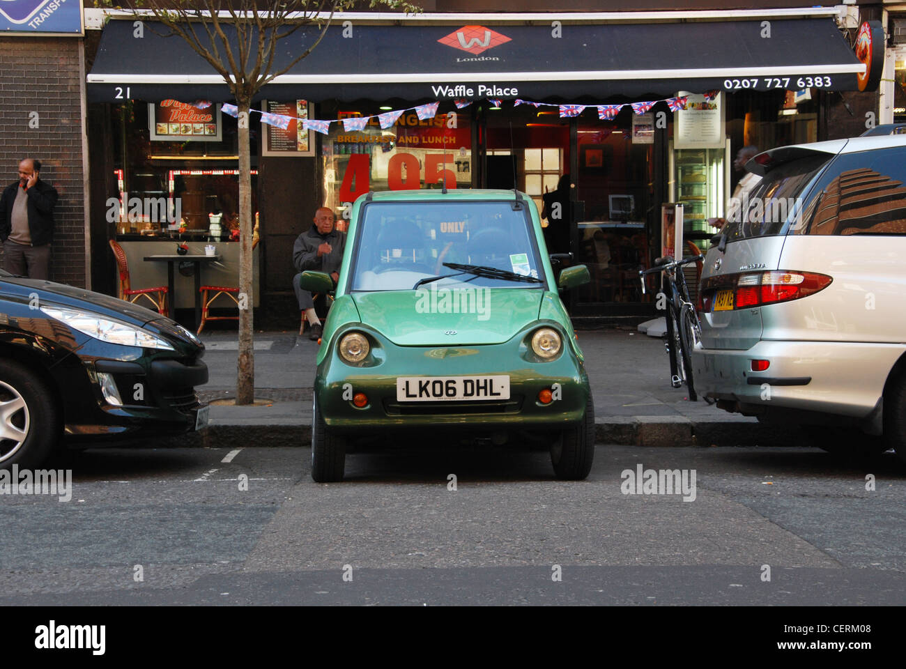 electric G-Wiz car parked in a tiny space London Hampstead Stock Photo