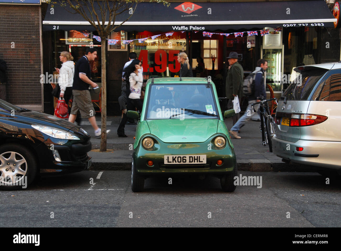 electric G-Wiz car parked in a tiny space London Hampstead Stock Photo