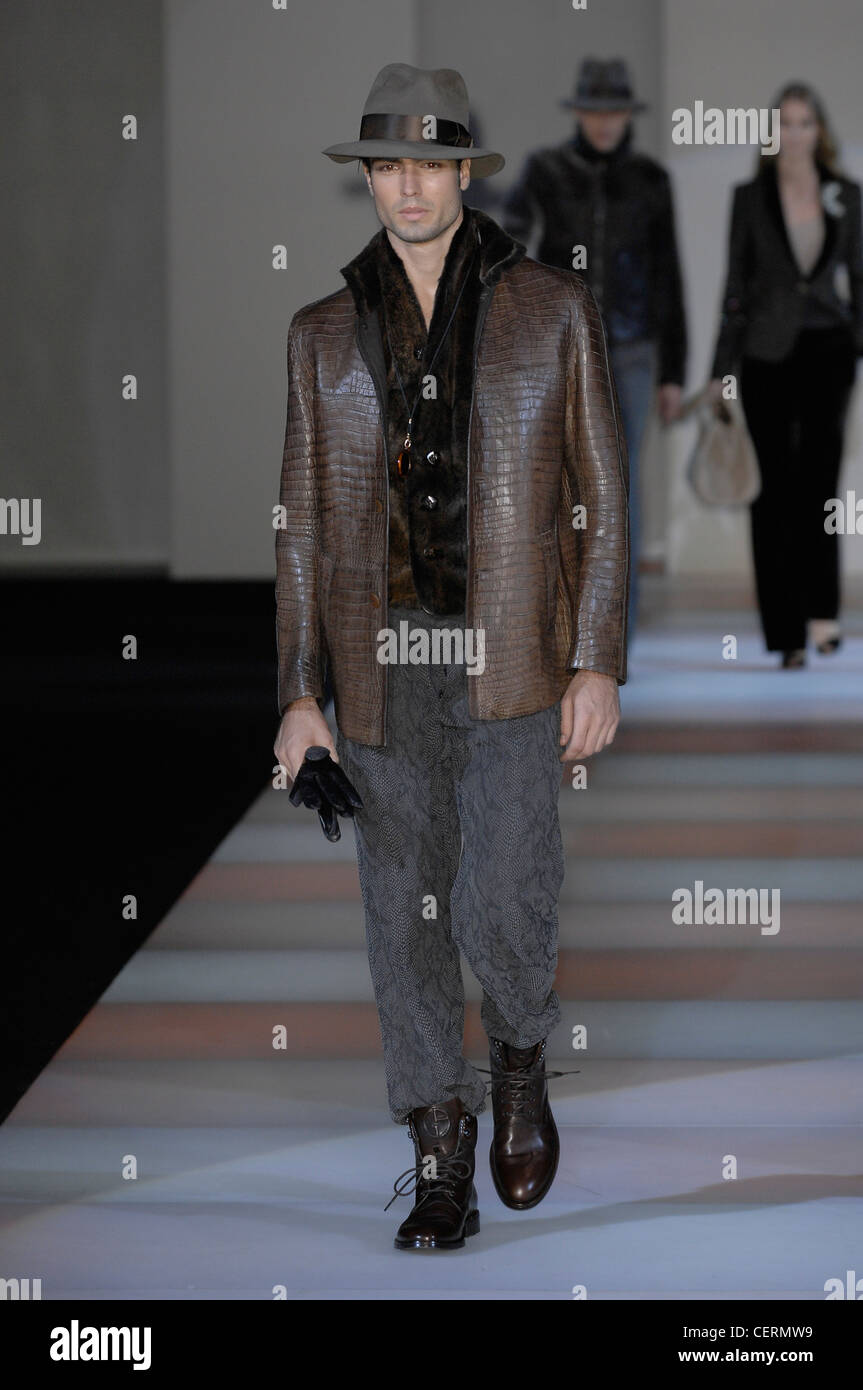 Giorgio Armani Milan Ready to Wear Autumn Winter  Brown snakeskin jacket over velvet waistcoat, grey print trousers tucked into Stock Photo
