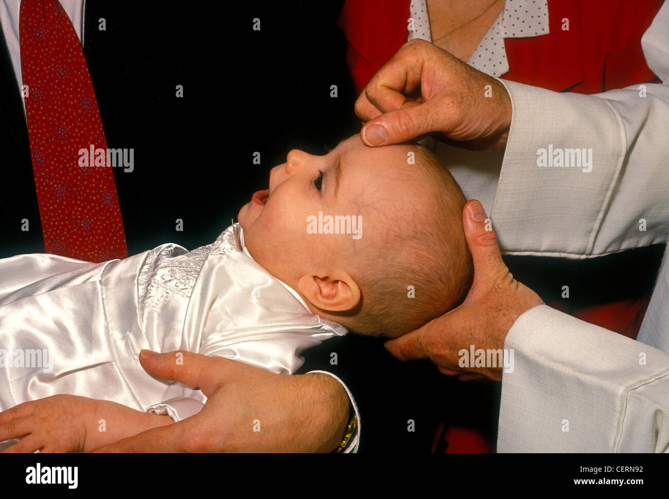Roman Catholic priest, baptism, christening, baptizing baby, baby, baptizing boy, boy, church service, religious service, Novato, California Stock Photo