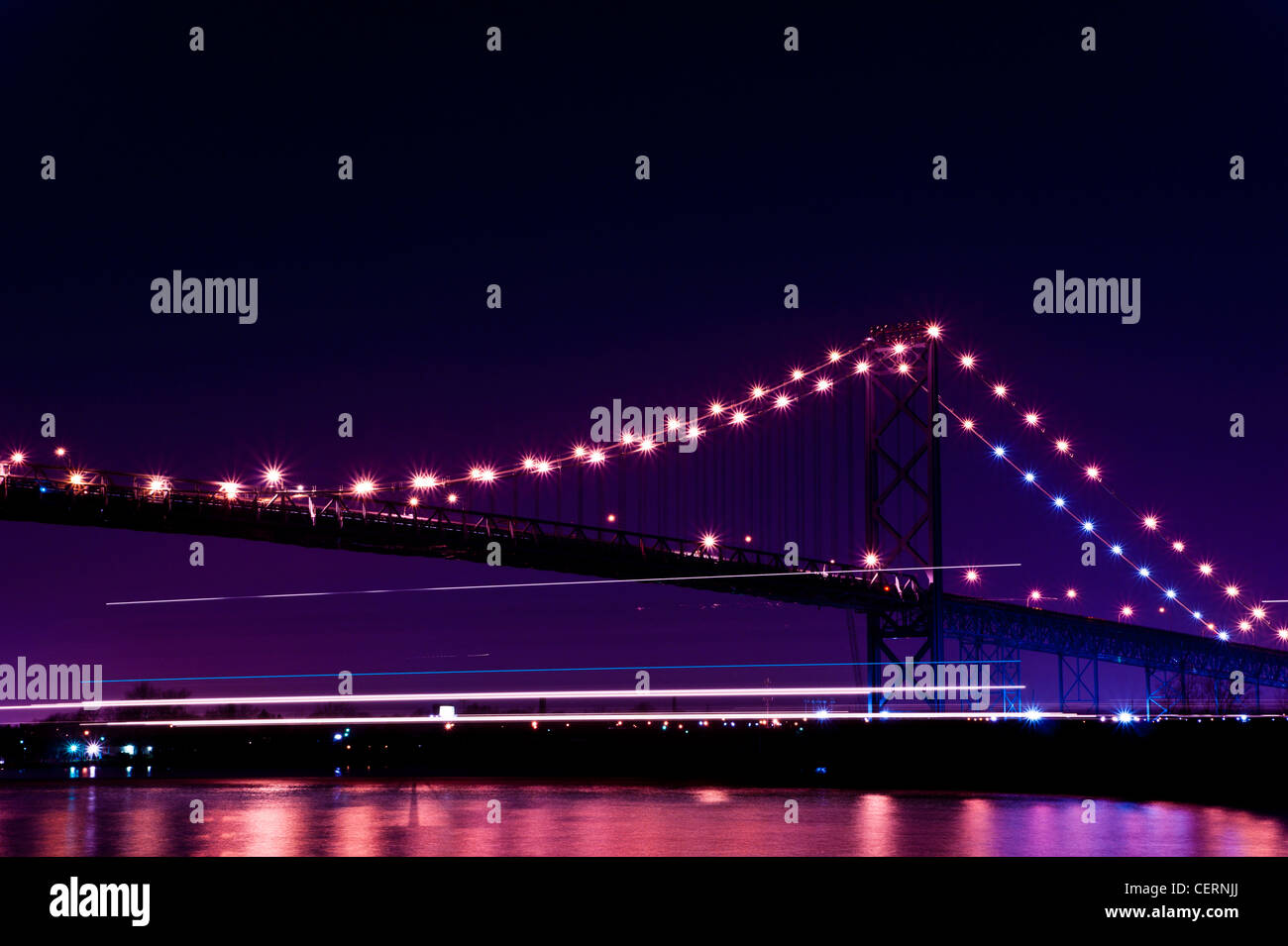 A ship's lights passing under the Ambassador Bridge between Windsor, Ontario and Detroit, Michigan Stock Photo