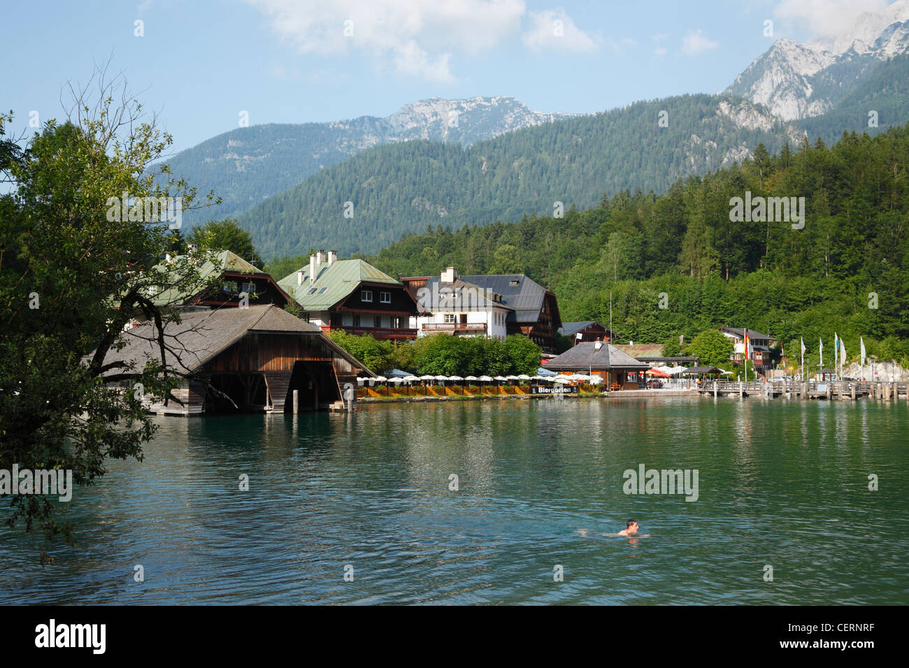 Young swimmer and people bathing in Lake Königsee, Berchtesgaden, Bavaria, Germany, on a hot summer day Stock Photo