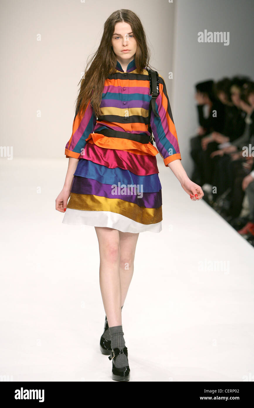PPQ London Ready to Wear Autumn Winter Multicolour stripe raw silk skirt and blouse, grey socks, patent shoes Stock Photo