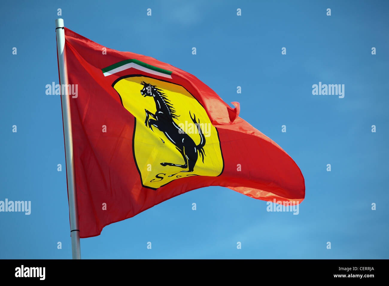 Ferrari flag flying against a blue sky Stock Photo