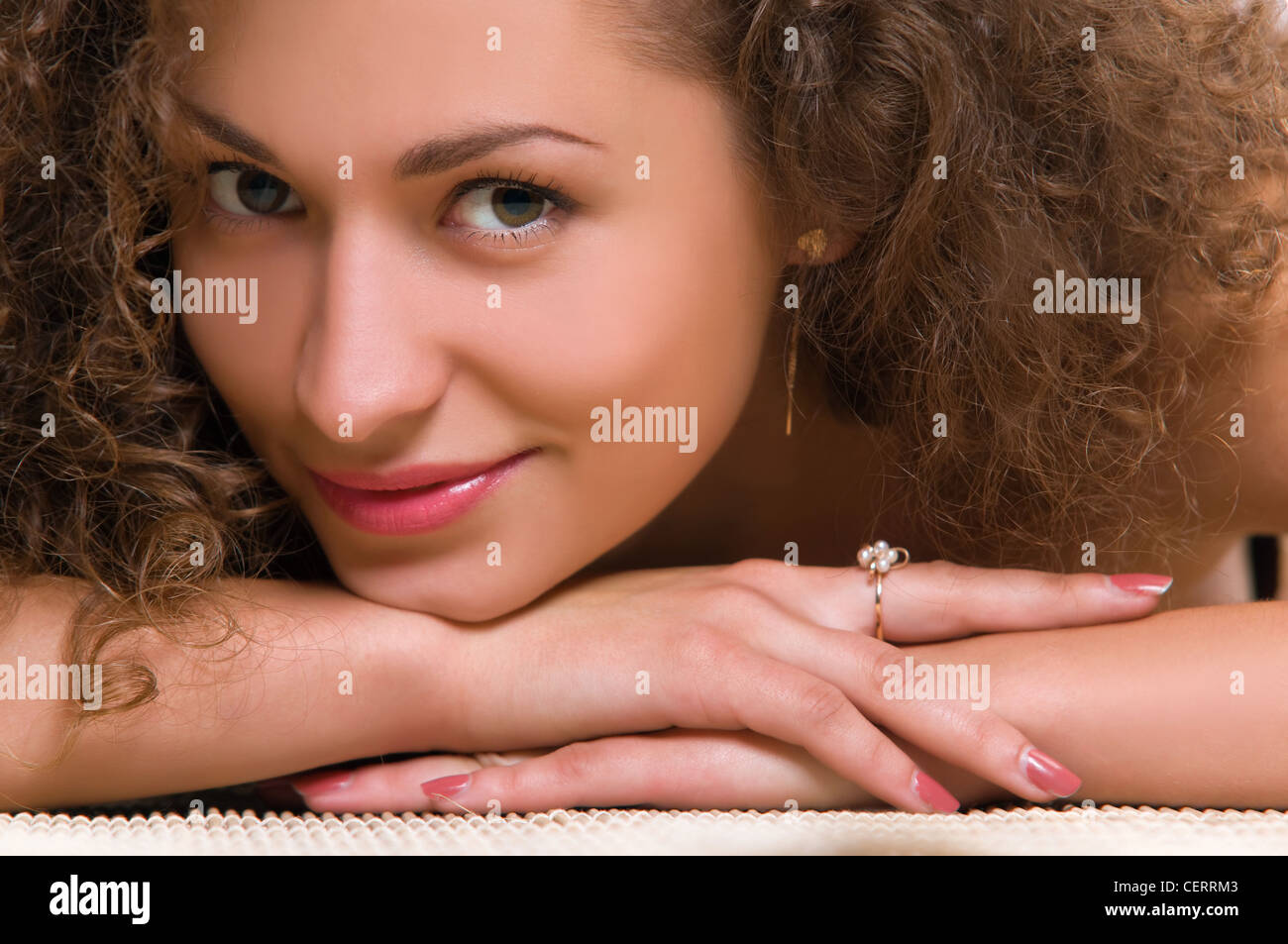 Portrait of an attractive young woman with curly hair Stock Photo - Alamy