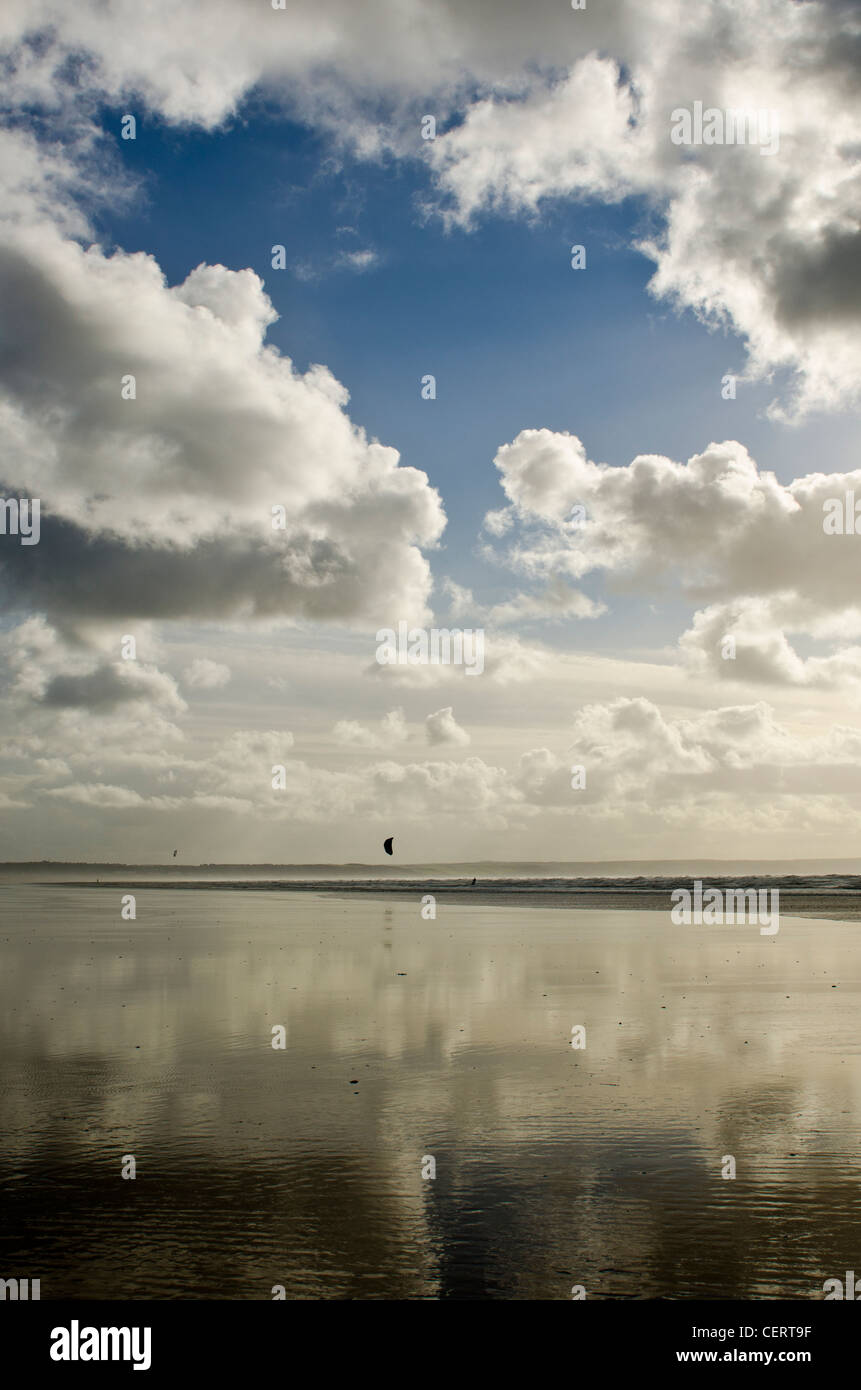 Low tide with wet sands blue sky and surfing at Saunton Sands, Devon Stock Photo