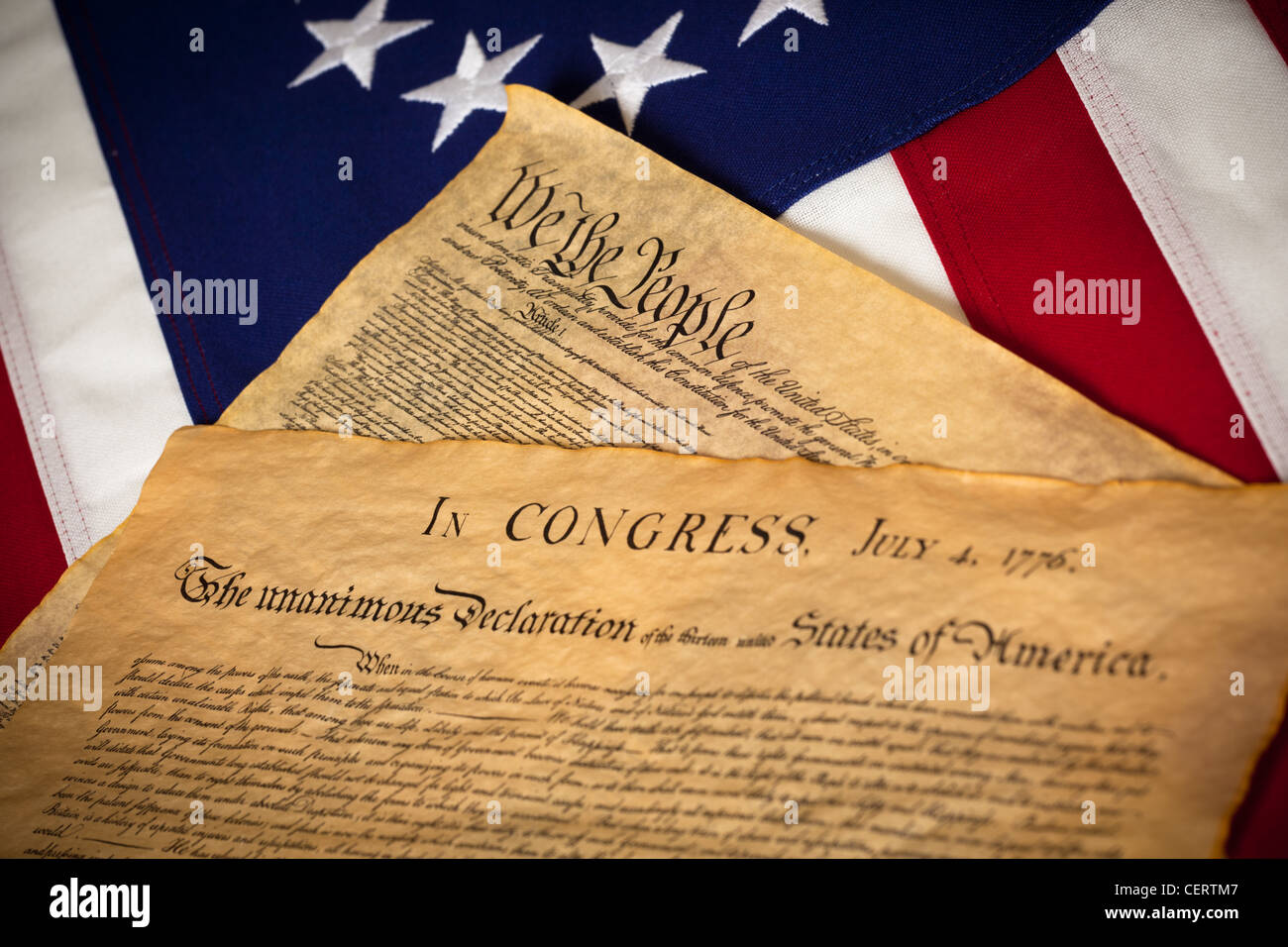 The Declaration of Independence and Contstitution of the United States of America in front of an American flag Stock Photo