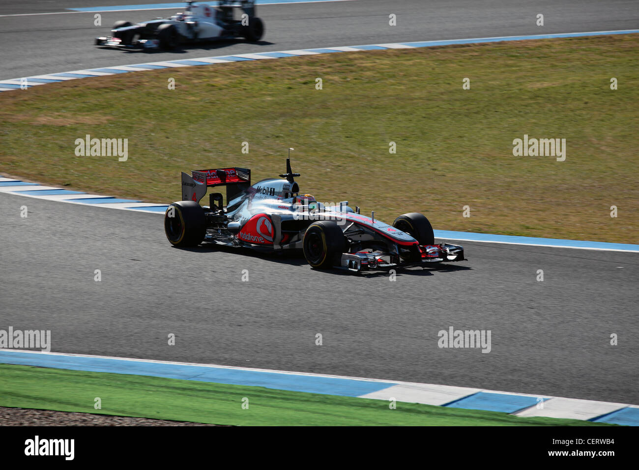 Lewis Hamilton driving McLaren F1 racing car during winter track