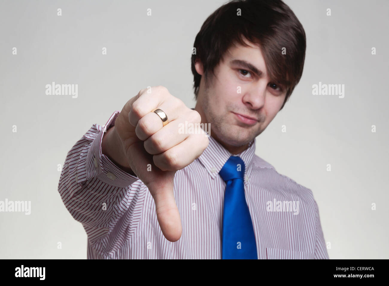 business looking man in a shirt and tie doing hand gestures, thumbs dowm Stock Photo