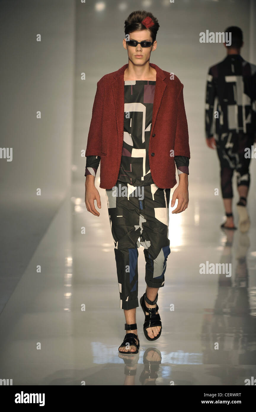 Giuliano Fujiwara Milan Ready to Wear Spring Summer Model wearing multi  coloured geometric patterned trousers and matching Stock Photo - Alamy