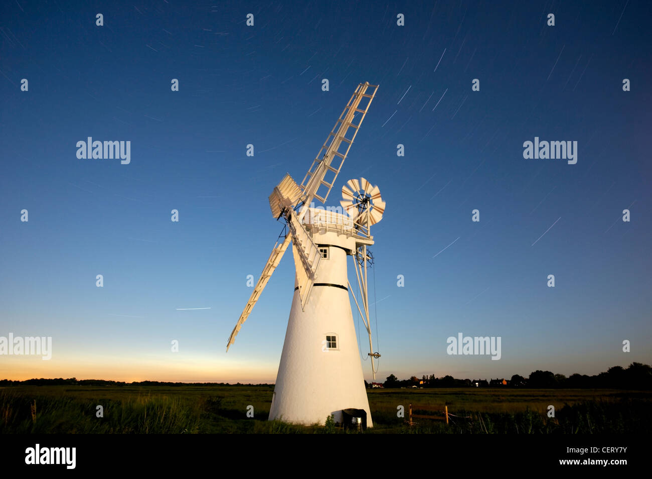 Thurne Windmill at night with star trails. Stock Photo