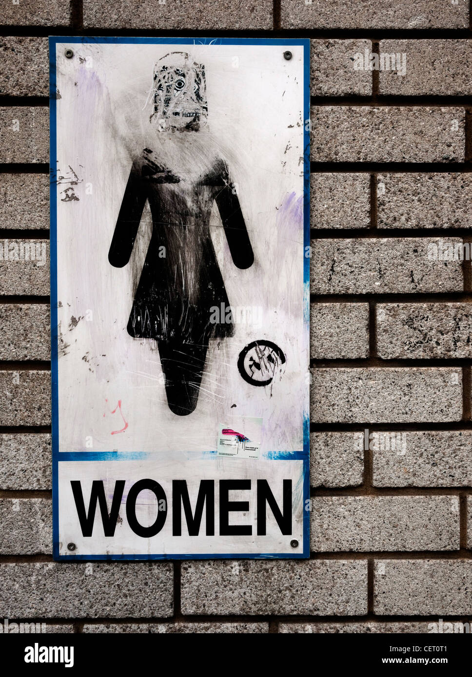 Womans public toilet sign in Bristol graffitied Stock Photo