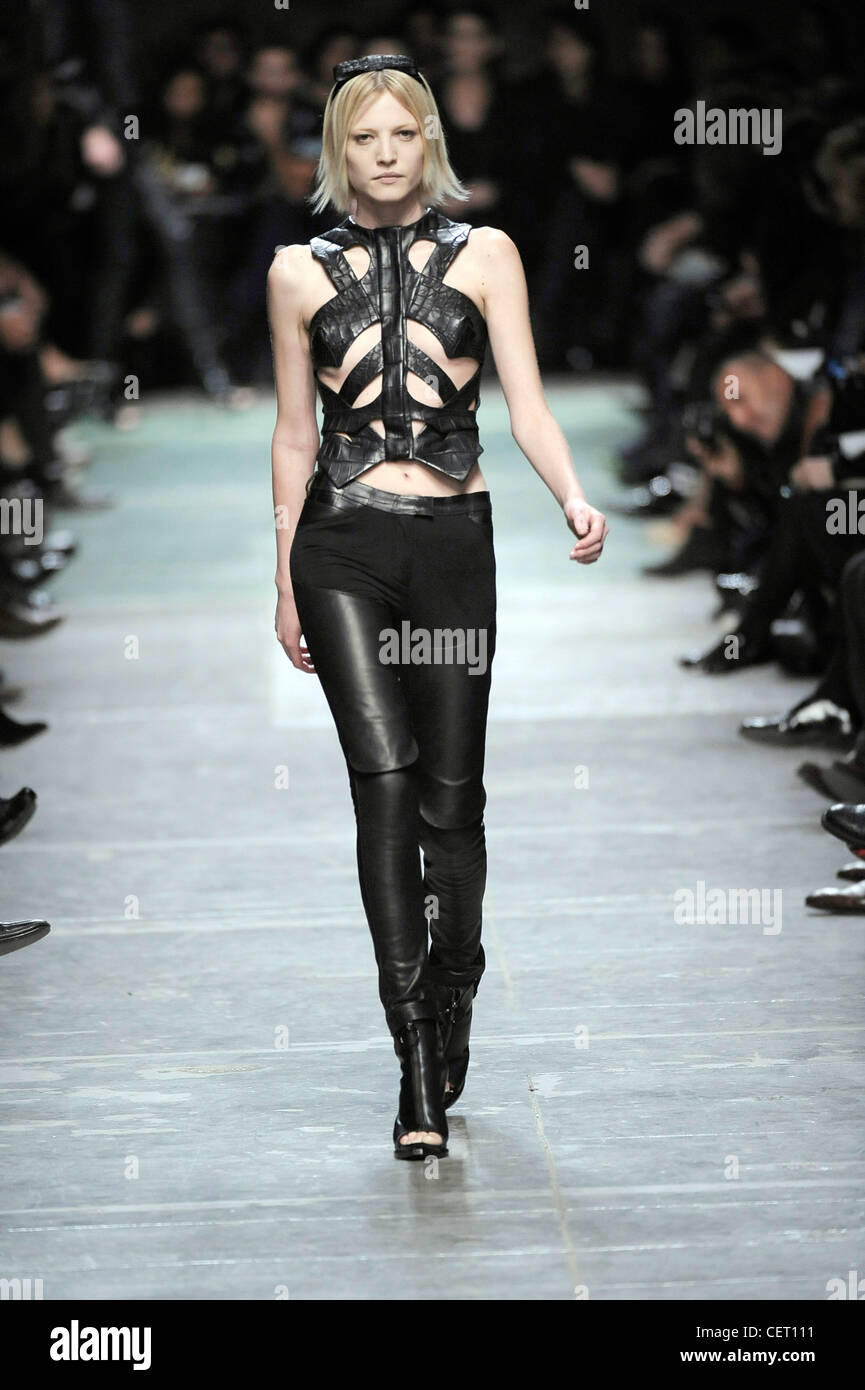 Givenchy Paris Ready to Wear Spring Summer Model wearing black leather  chaps style tight trousers, a cut out detail black Stock Photo - Alamy