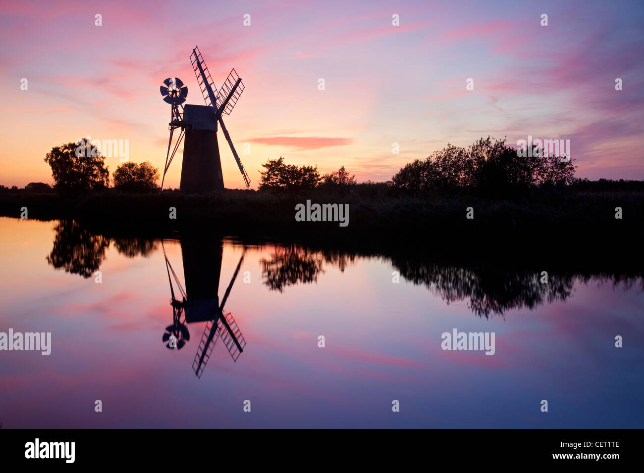 Turf Fen drainage mill at sunset on the River Ant in the Norfolk Broads. Stock Photo