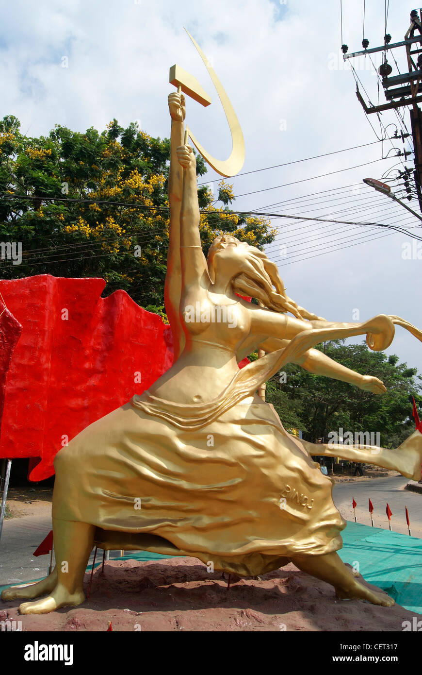 Communist Party Sculpture of working Men and women with raising Knife hammer Party logo.Placed near National Highway Kerala Stock Photo