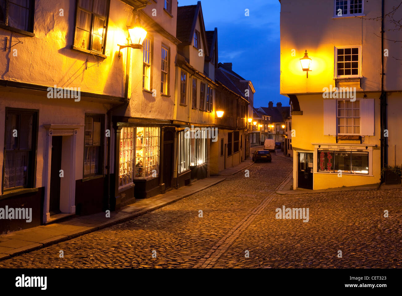 Elm Hill, an historic cobbled lane featuring many buildings from the Tudor period, illuminated at dusk. Stock Photo