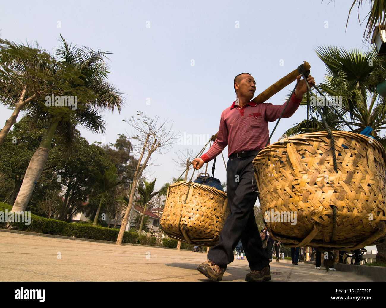 Carrying big baskets of fish in Xiamen, China Stock Photo Alamy