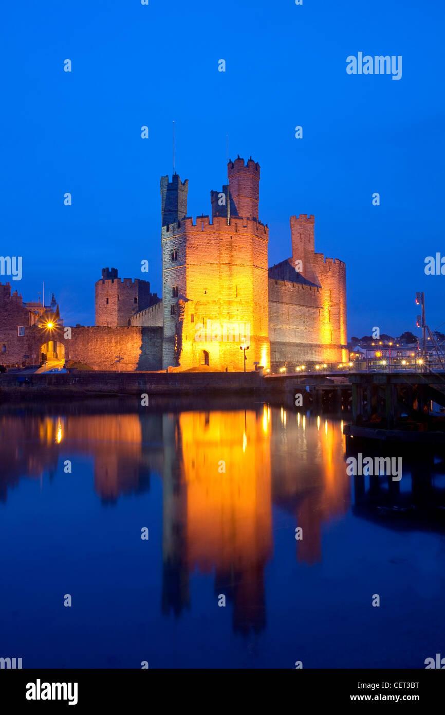 Caernarfon Castle at the mouth of the Seiont river at dusk. Stock Photo