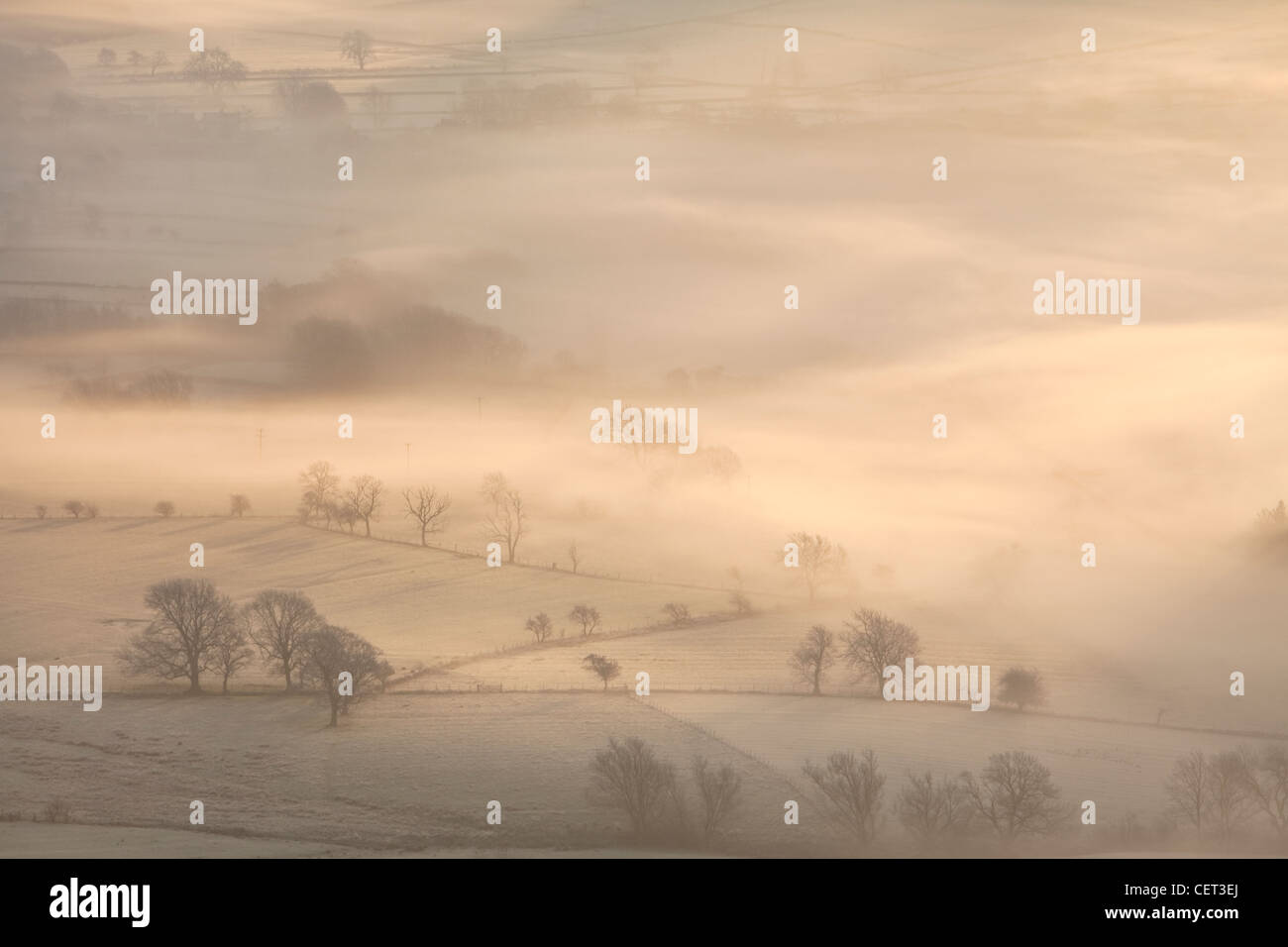 The Hope Valley shrouded in mist at dawn in the Peak District National Park. Stock Photo