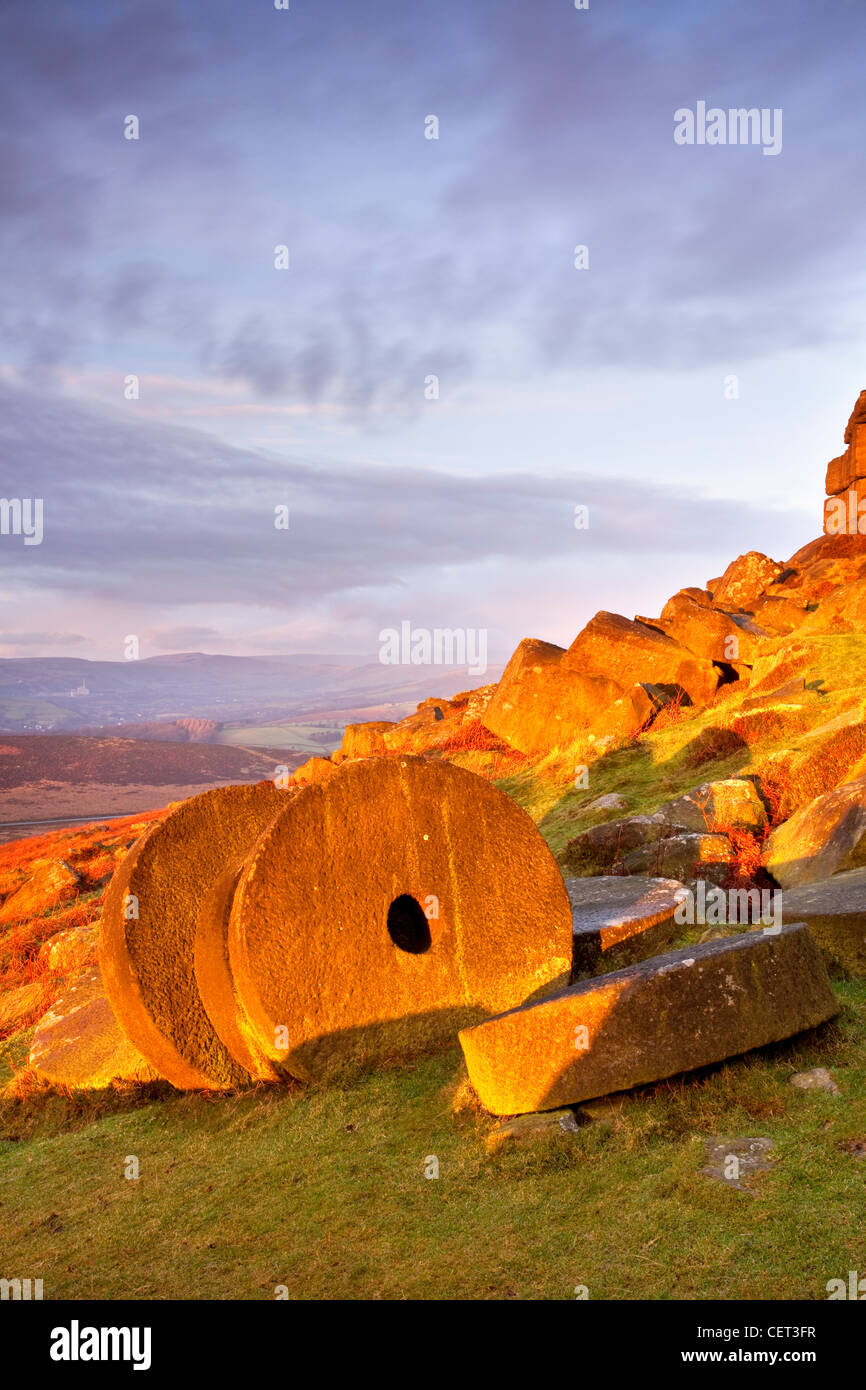 Abandoned millstones beneath Stanage Edge at first light in the Peak District National Park. Stock Photo