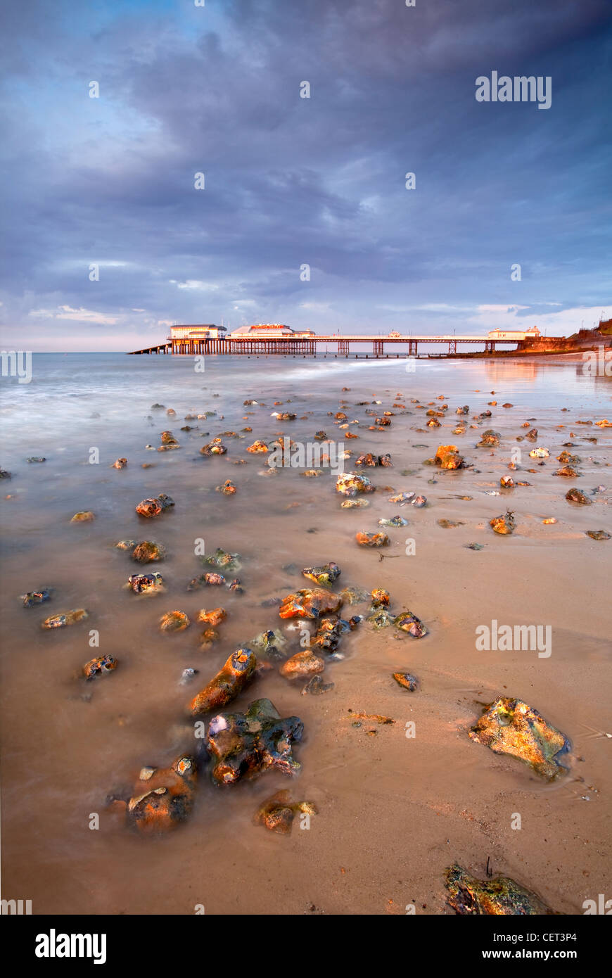 Stormy light over Cromer Pier shortly before sunset on the North Norfolk Coast. Stock Photo
