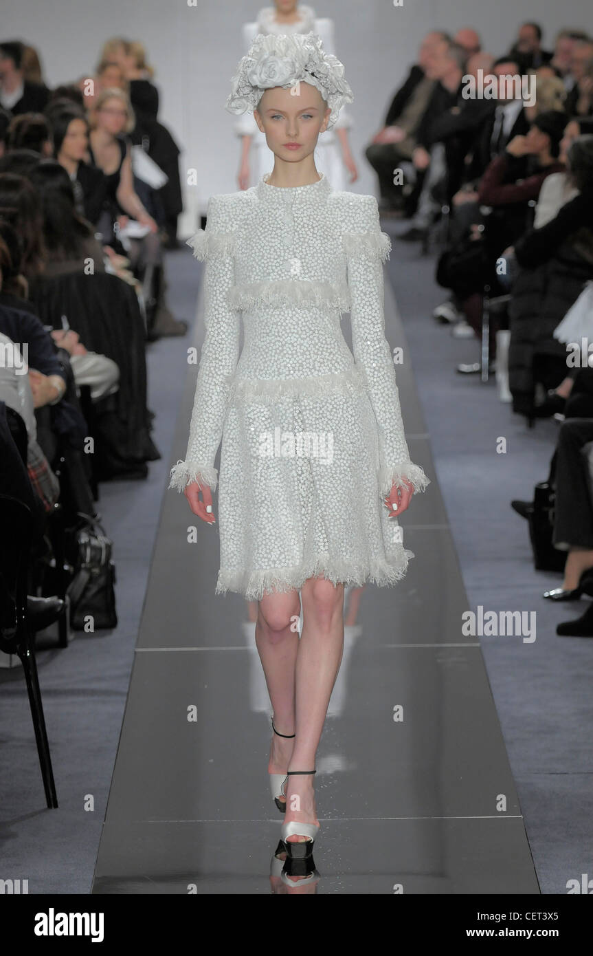 Chanel Paris Haute Couture Spring Summer Long sleeved iIvory polkadot dress  ruffled details, floral headdress and ankle strap Stock Photo - Alamy