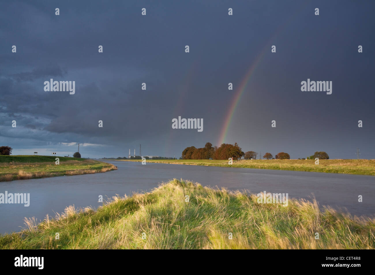 A double rainbow over the point at which the North level Main Drain enters the River Nene at Foul Anchor. Stock Photo