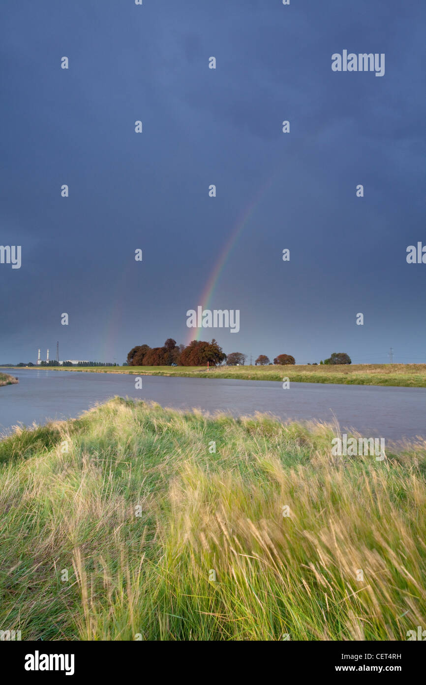 A double rainbow over the point at which the North level Main Drain enters the River Nene at Foul Anchor. Stock Photo