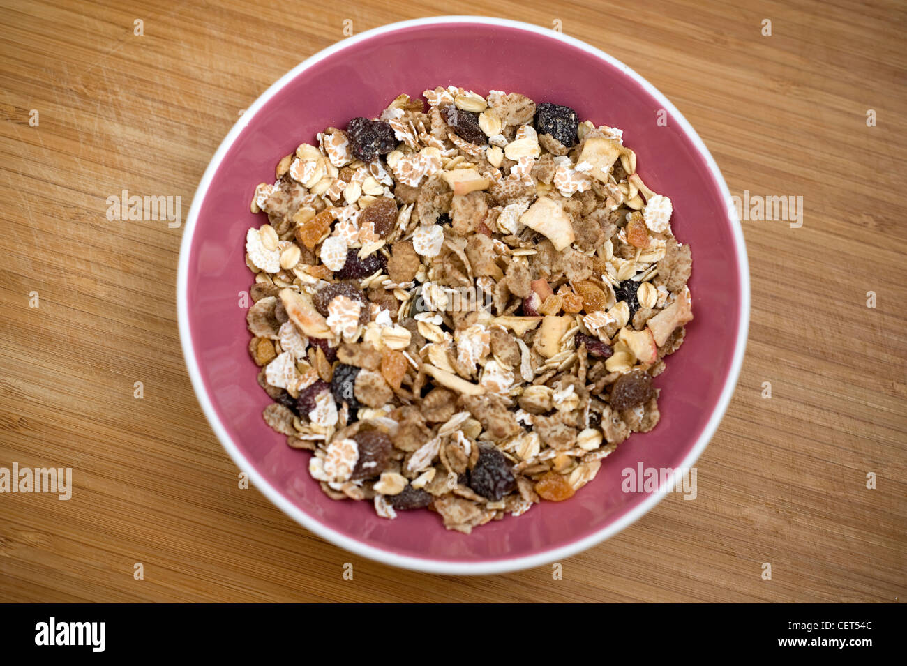 A pink bowl of muesli with dried fruit Stock Photo Alamy